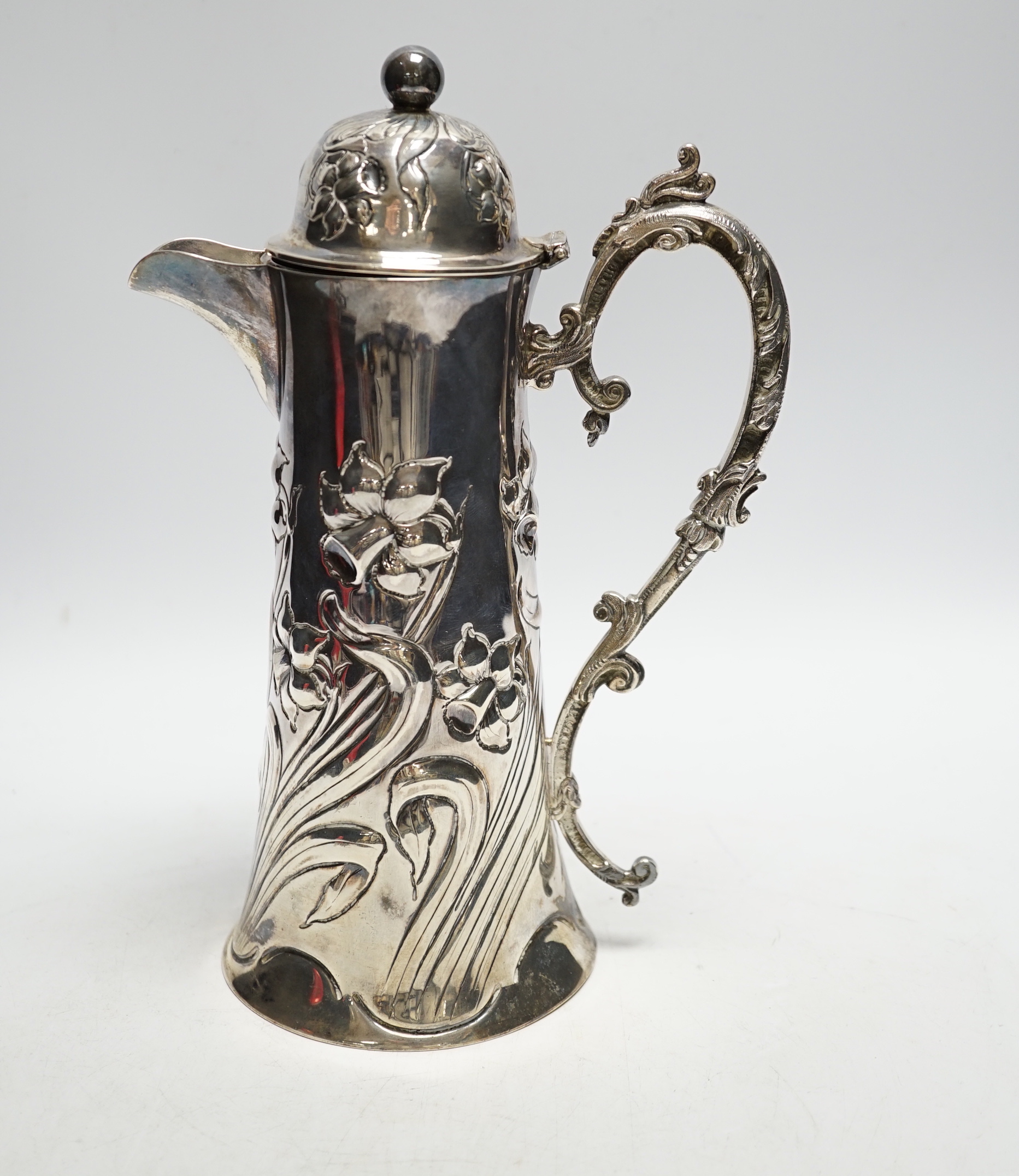 A late Victorian embossed silver jug, John Henry Potter, Sheffield, 1900, height 24.8cm, with replaced plated handle?, gross weight 22.6oz.